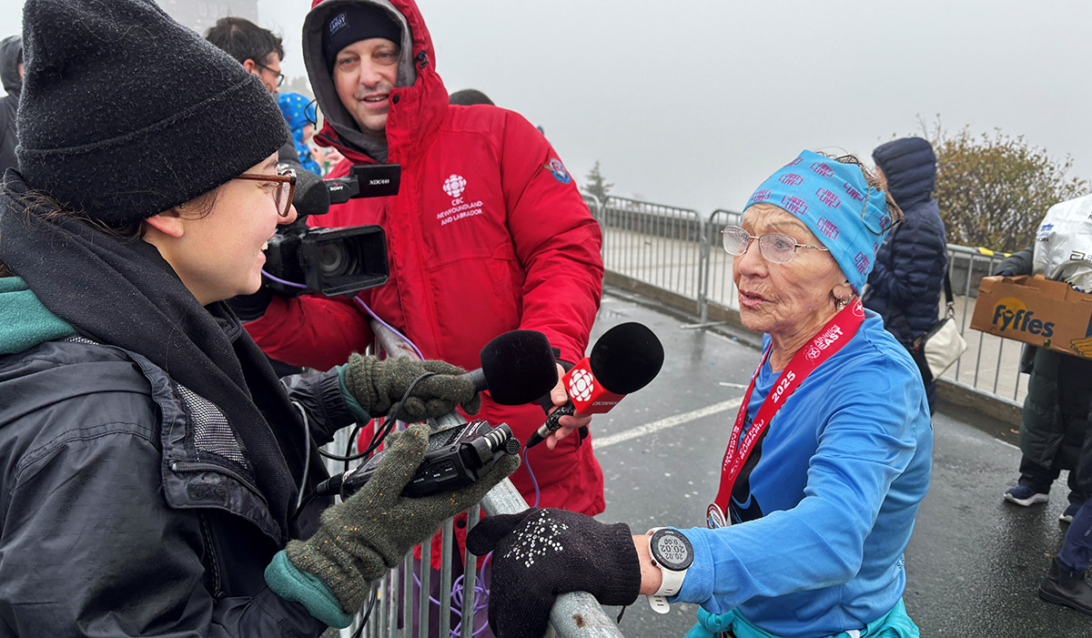 PHOTO - 87 year old Florence Barron doing and interview after running the Cape to Cabot 20k road race and winning the 80+ Female age category. in St John's October 19, 2025. Photo by Heather Barrett.