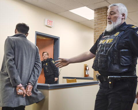 Jonathan Patten is led away in handcuffs by a sheriff after bieng convicted of impaired driving in provincial court at Harbour Grace, Newfoundland, April 14, 2026. Photo by Greg Locke © 2026
