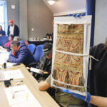 Baily Andrew, member of Sheshatshiu Innu First Nation and student at Memorial University holds a Innu caribou hunter's carrying bag during a workshop on Innu historic artifacts at The Rooms in St John's, Newfoundland January 26, 2026. Photo by Greg Locke.