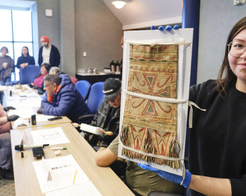 Baily Andrew, member of Sheshatshiu Innu First Nation and student at Memorial University holds a Innu caribou hunter's carrying bag during a workshop on Innu historic artifacts at The Rooms in St John's, Newfoundland January 26, 2026. Photo by Greg Locke.