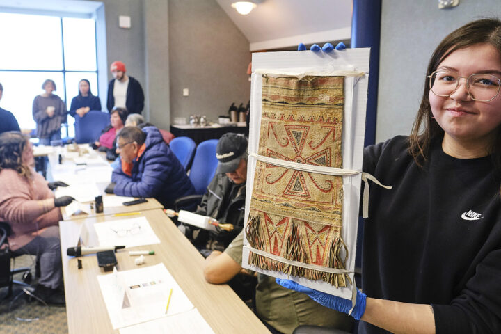 Baily Andrew, member of Sheshatshiu Innu First Nation and student at Memorial University holds a Innu caribou hunter's carrying bag during a workshop on Innu historic artifacts at The Rooms in St John's, Newfoundland January 26, 2026. Photo by Greg Locke.