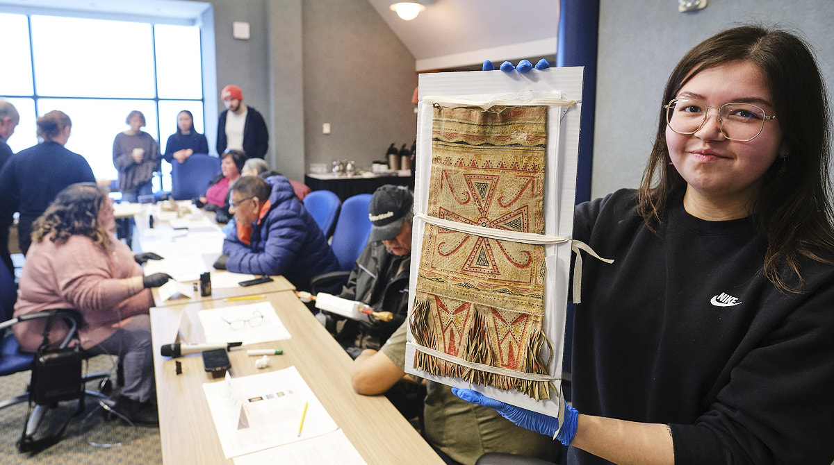 Baily Andrew, member of Sheshatshiu Innu First Nation and student at Memorial University holds a Innu caribou hunter's carrying bag during a workshop on Innu historic artifacts at The Rooms in St John's, Newfoundland January 26, 2026. Photo by Greg Locke.